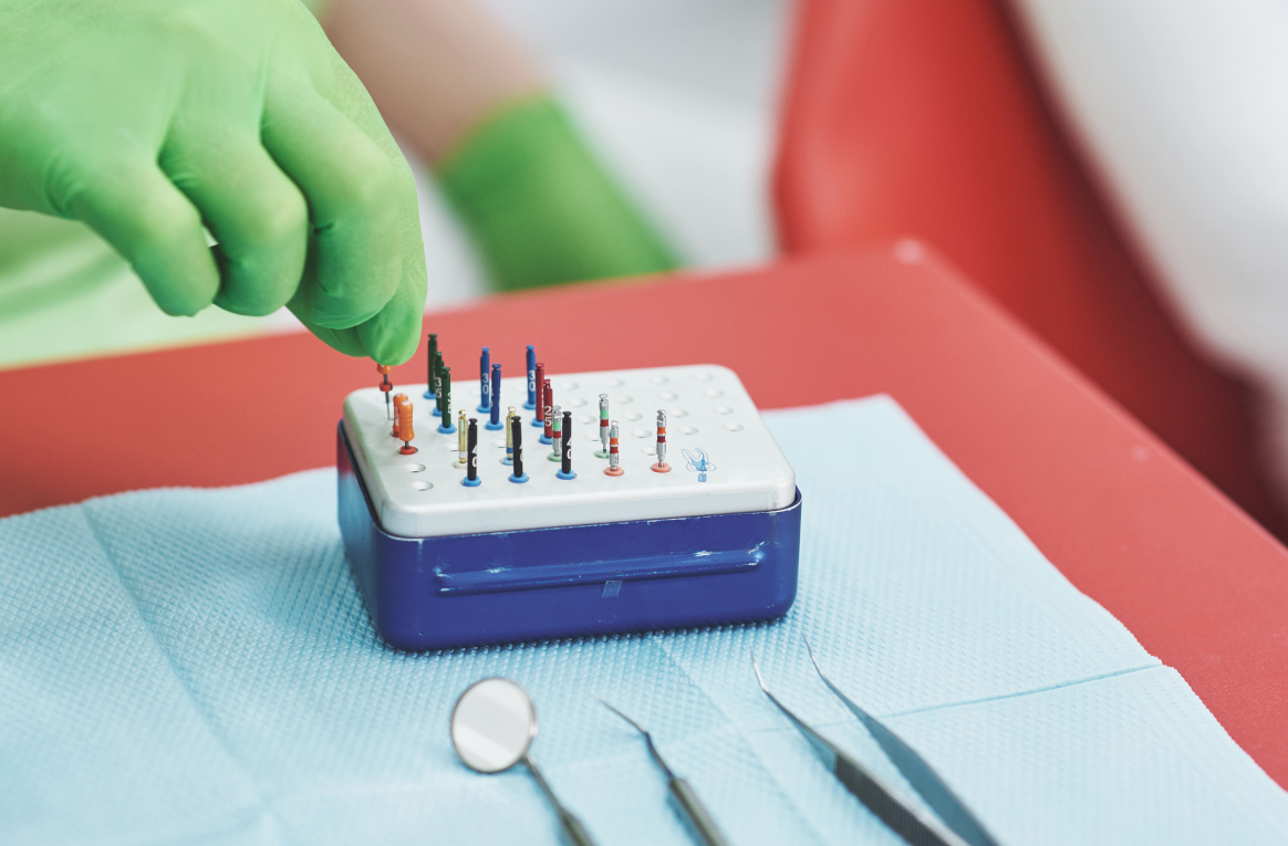 Stomatologist and her assistant treating woman for dental cavity