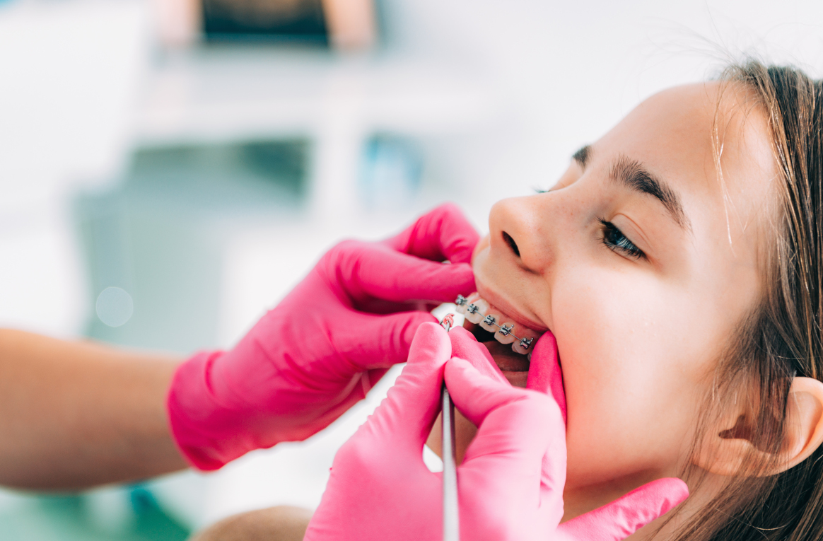 Stomatologist and her assistant treating woman for dental cavity