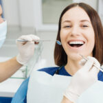 caucasian-male-dentist-examining-young-woman-patient-s-teeth-dental-clinic