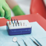 Stomatologist and her assistant treating woman for dental cavity